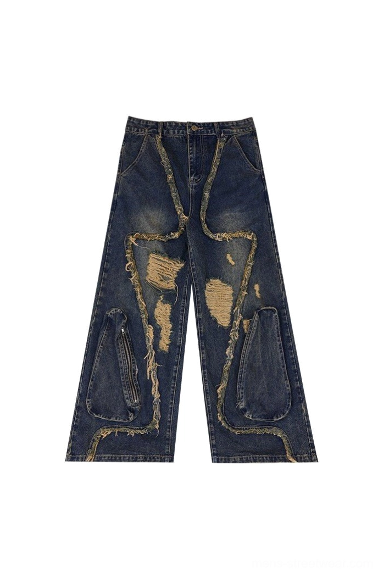 Flat lay of vintage indigo deconstructed wide leg ripped jeans with exposed frayed seams, cutout panels, belt loops and zipper pockets