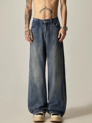 Front full body view of retro fade ultra-wide leg washed blue denim jeans with classic pockets and relaxed streetwear fit