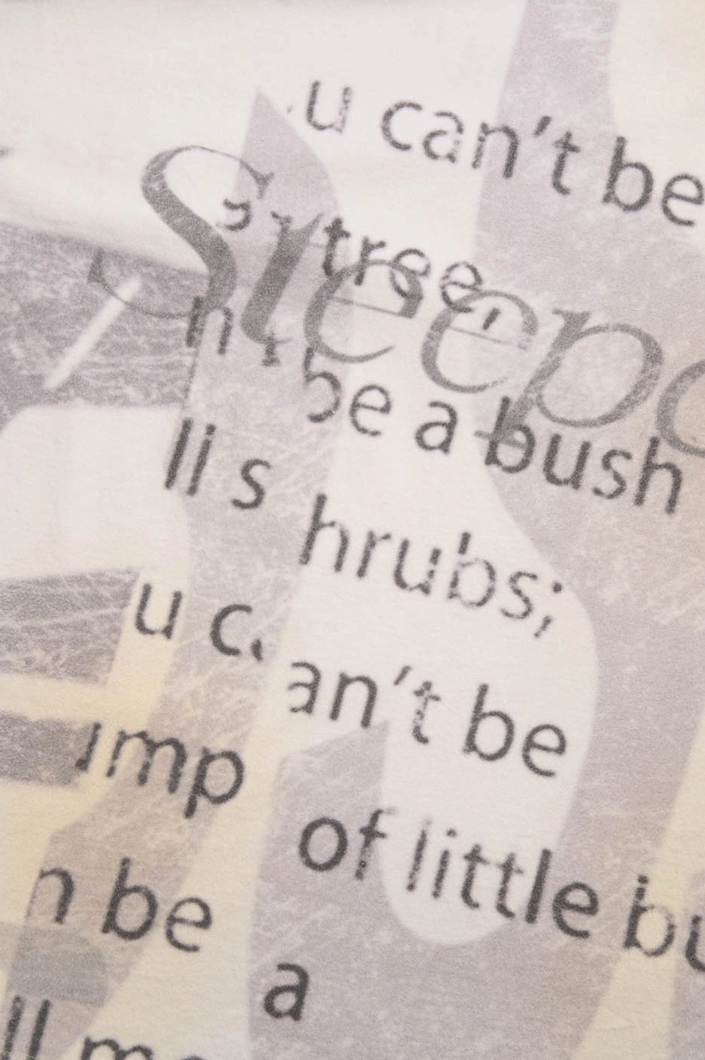 Detailed view of the retro faded text graphic printed on a cream oversized Korean streetwear T-shirt