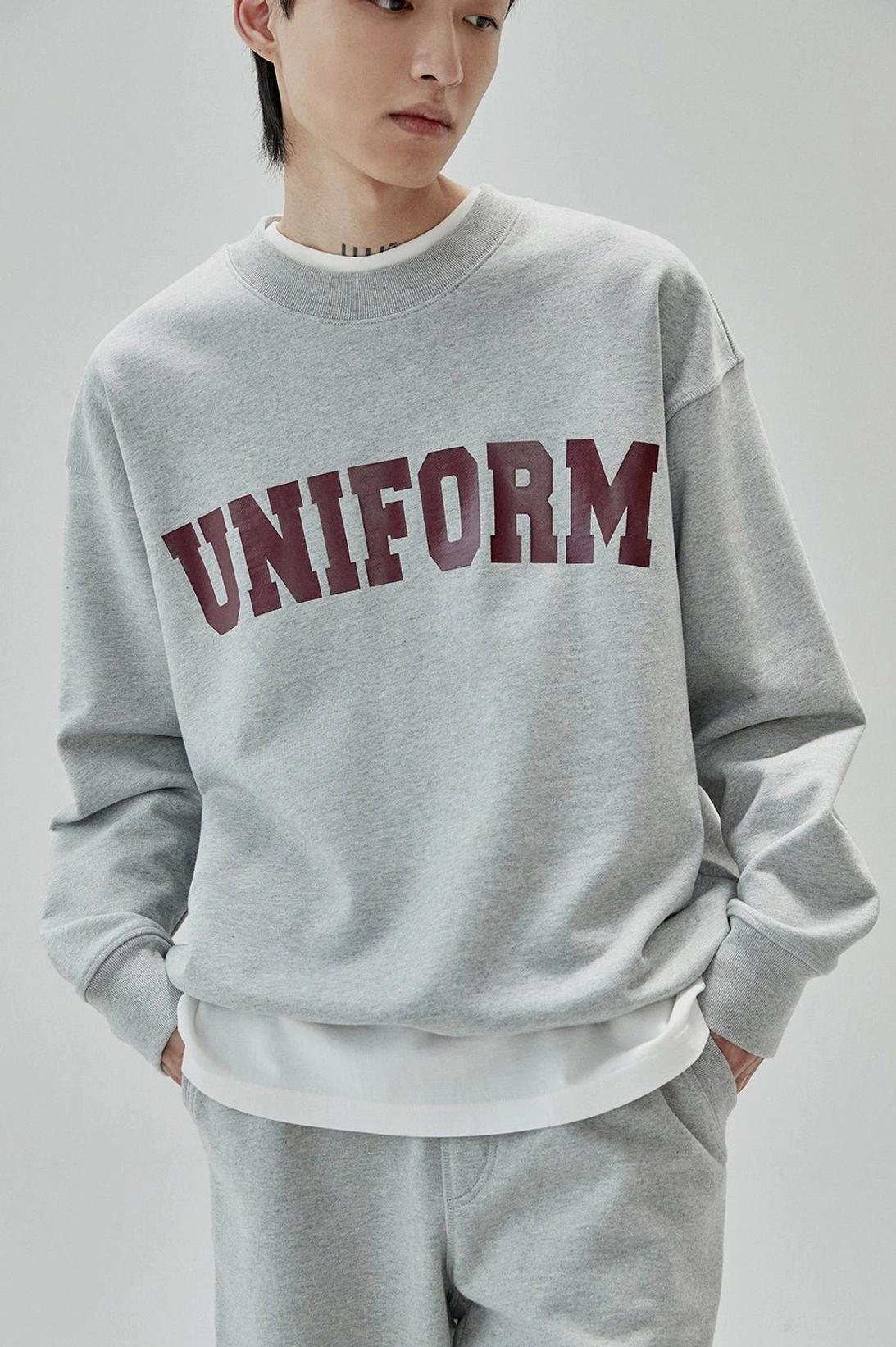 Retro streetwear crewneck sweatshirt featuring tactile rubber printed UNIFORM graphic