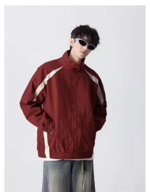 Model wearing a wine red retro stripe nylon track windbreaker with off-white contrast stripes and a stand collar