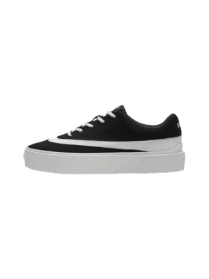 Side view of black suede-look colorblock platform sneakers with white stripe and thick rubber outsole