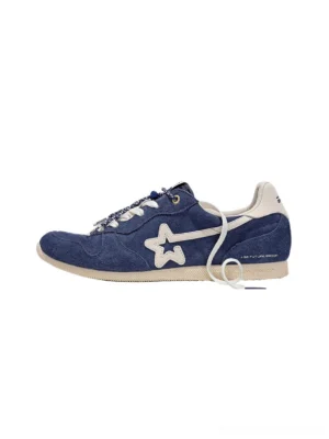 Navy blue retro low-profile suede panel trainers with white star side detail and off-white rubber sole in side view
