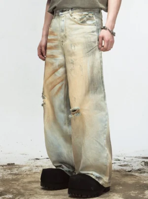 Side view of vintage yellow washed distressed wide-leg denim jeans with ripped knee detail