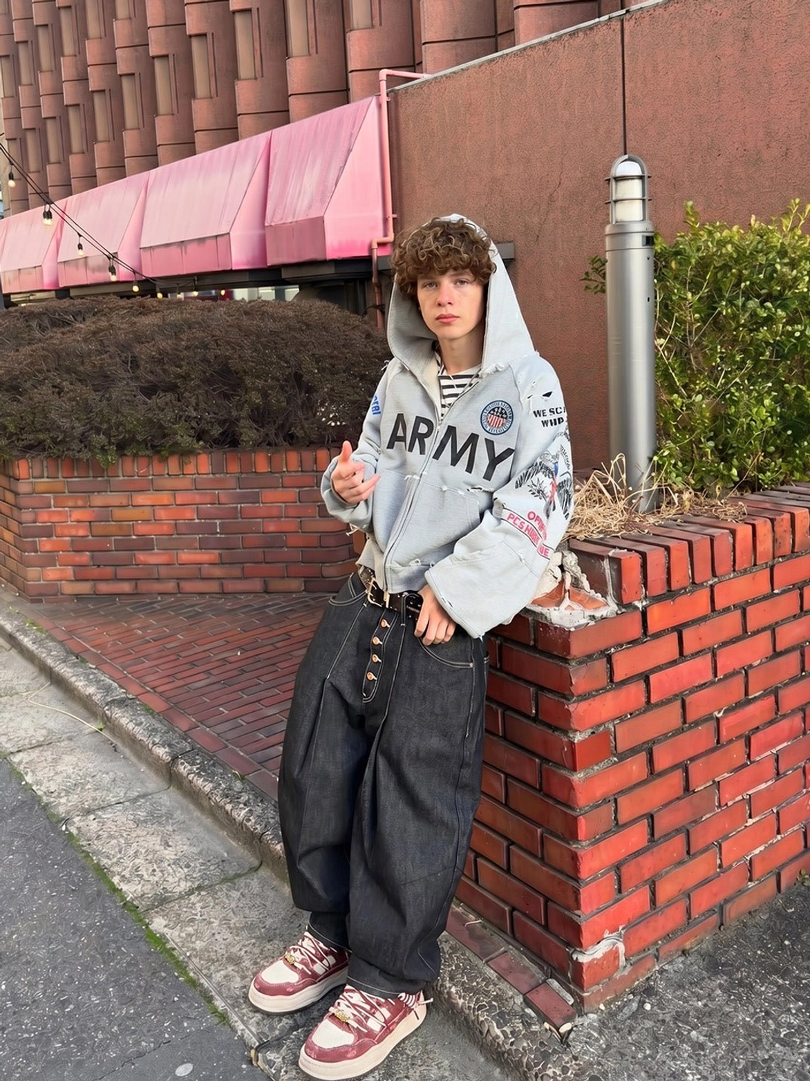 Retro washed denim sneakers styled with a printed army hoodie and wide-leg denim trousers in a casual Seoul-inspired streetwear look