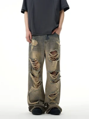 Retro washed distressed wide-leg ripped jeans front low-angle view with shredded holes and loose streetwear fit
