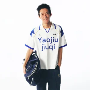 Front view of a retro white and blue contrast-panel V-neck football jersey with Yaojiu jiuqi typography, styled with navy sport pants and a dark duffel bag