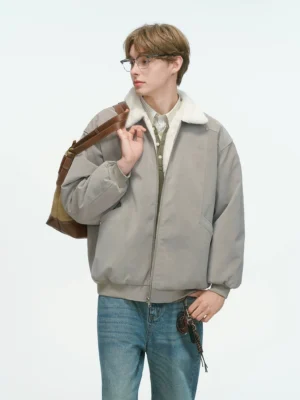 Light gray reversible shearling collar bomber jacket in relaxed Korean streetwear style worn with layered tops and blue jeans