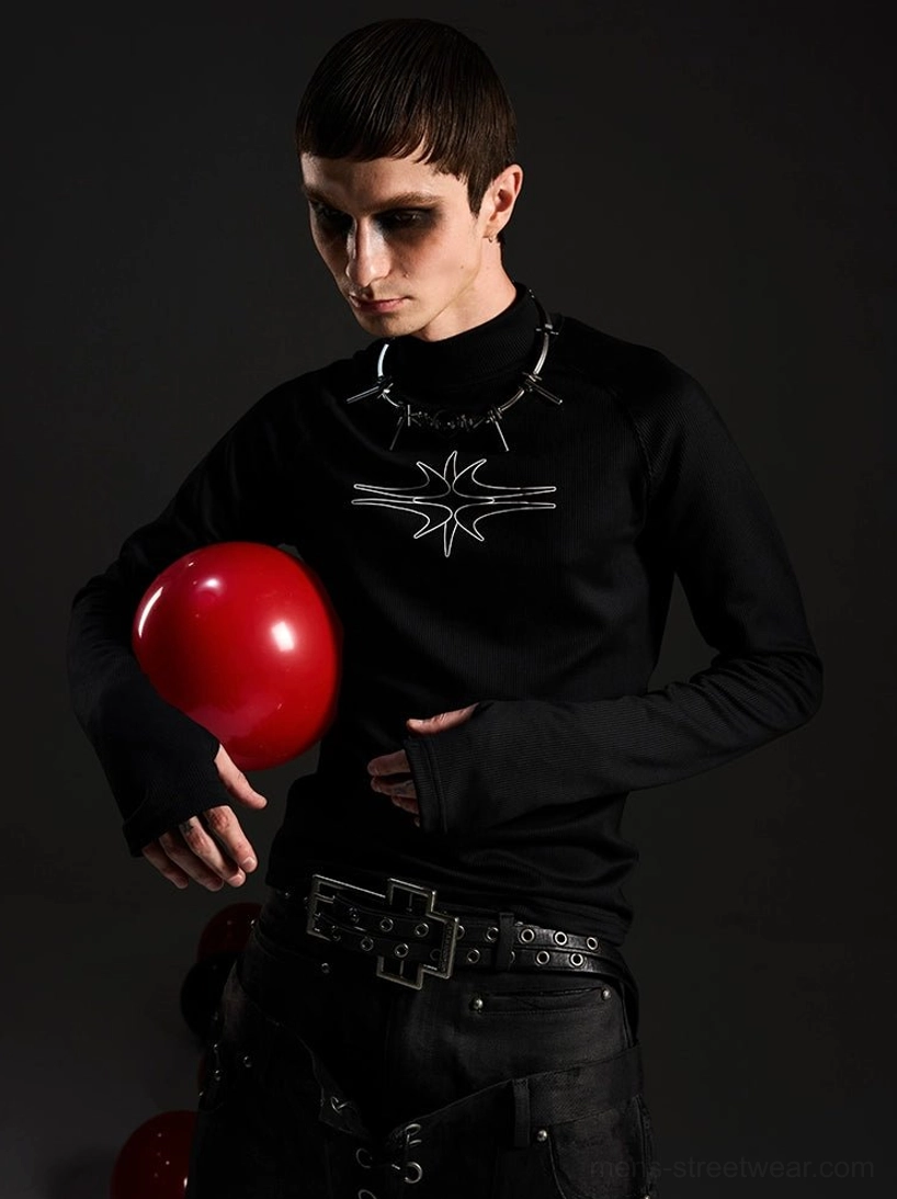 Front detail of ribbed black gothic mockneck top with contrasting star chest graphic, punk belt, and spiked choker