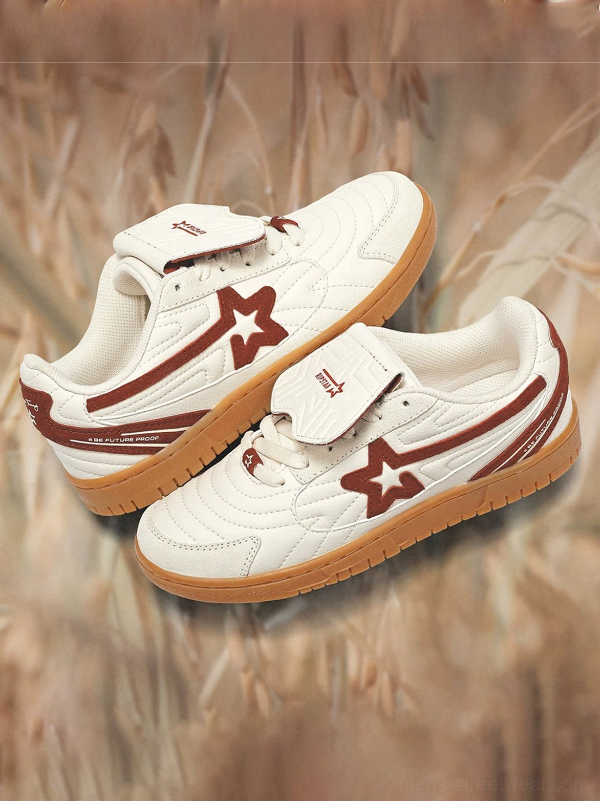 Pair of rice red star panel retro court sneakers arranged on dry grass showing layered tongues and gum rubber outsoles