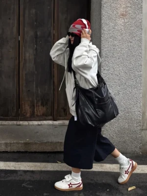 Rice red star panel retro court sneakers worn with black wide-leg pants and grey hoodie in an urban streetwear setting