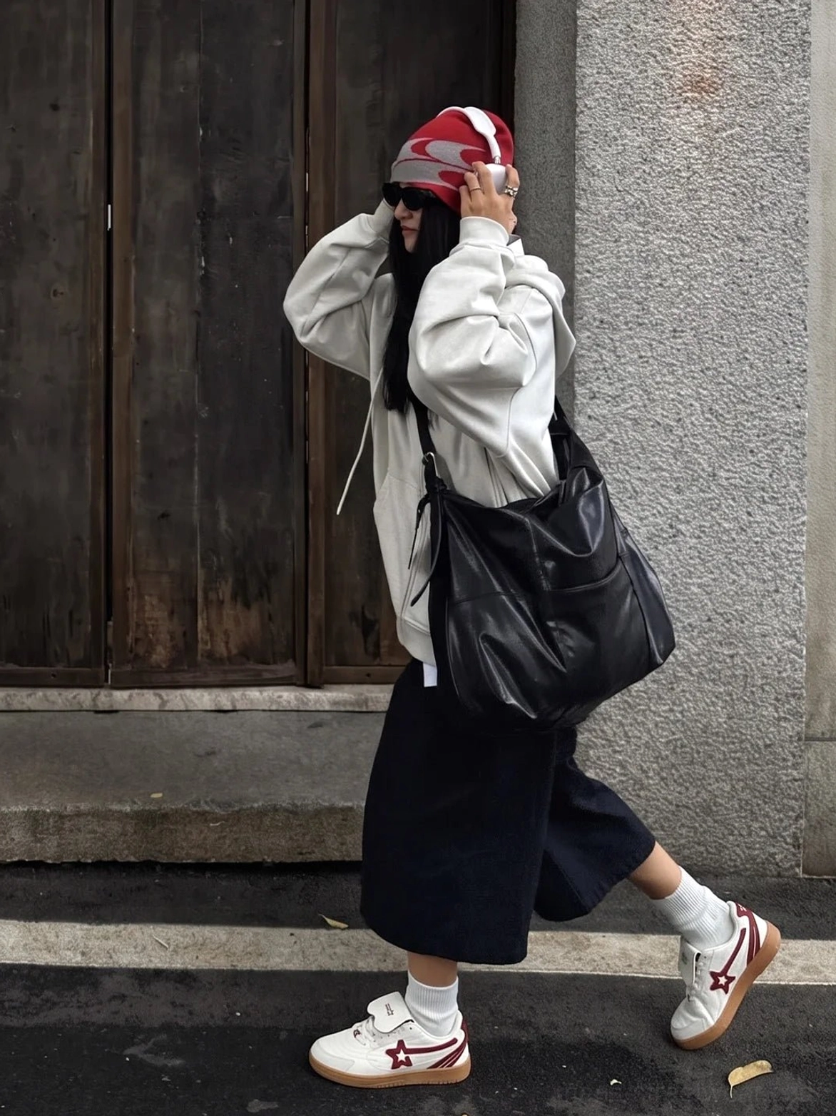 Rice red star panel retro court sneakers worn with black wide-leg pants and grey hoodie in an urban streetwear setting