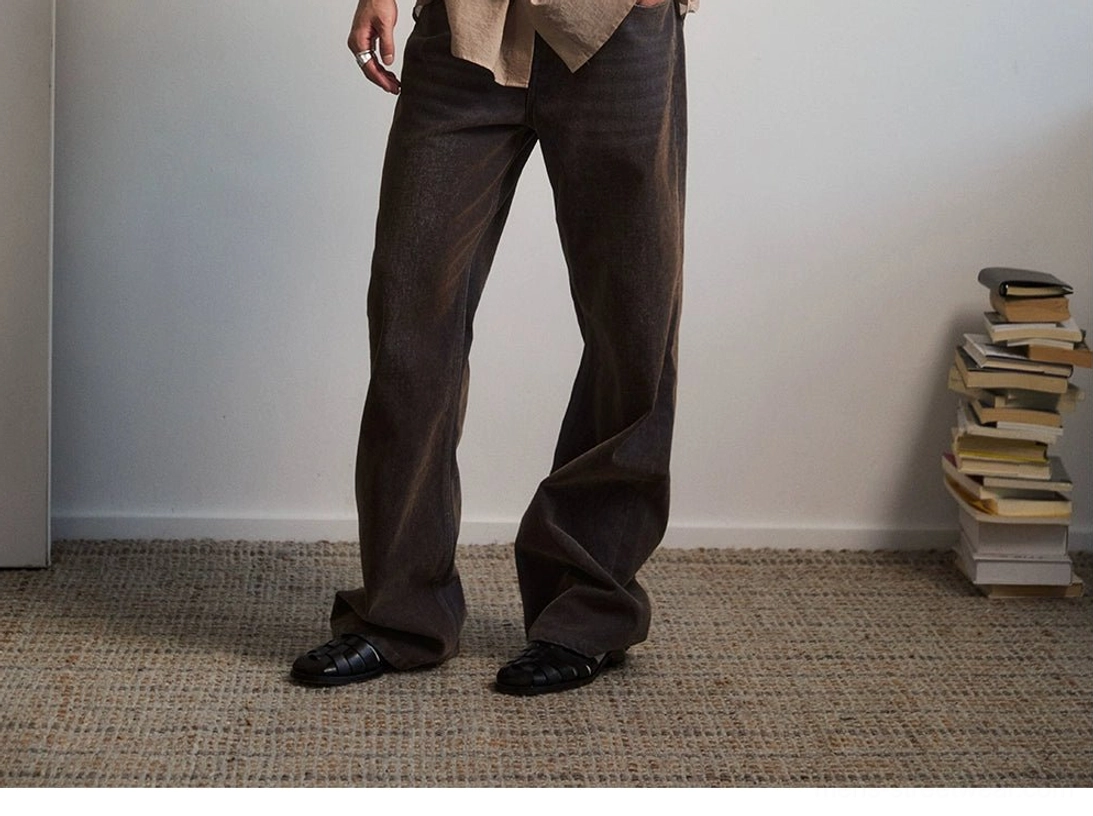 Rich dark brown high rise flare jeans side full body view with subtle vintage washed denim texture