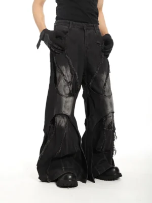 Riftcore shredded super flare distressed black jeans front three quarter view with faded wash and frayed panel details