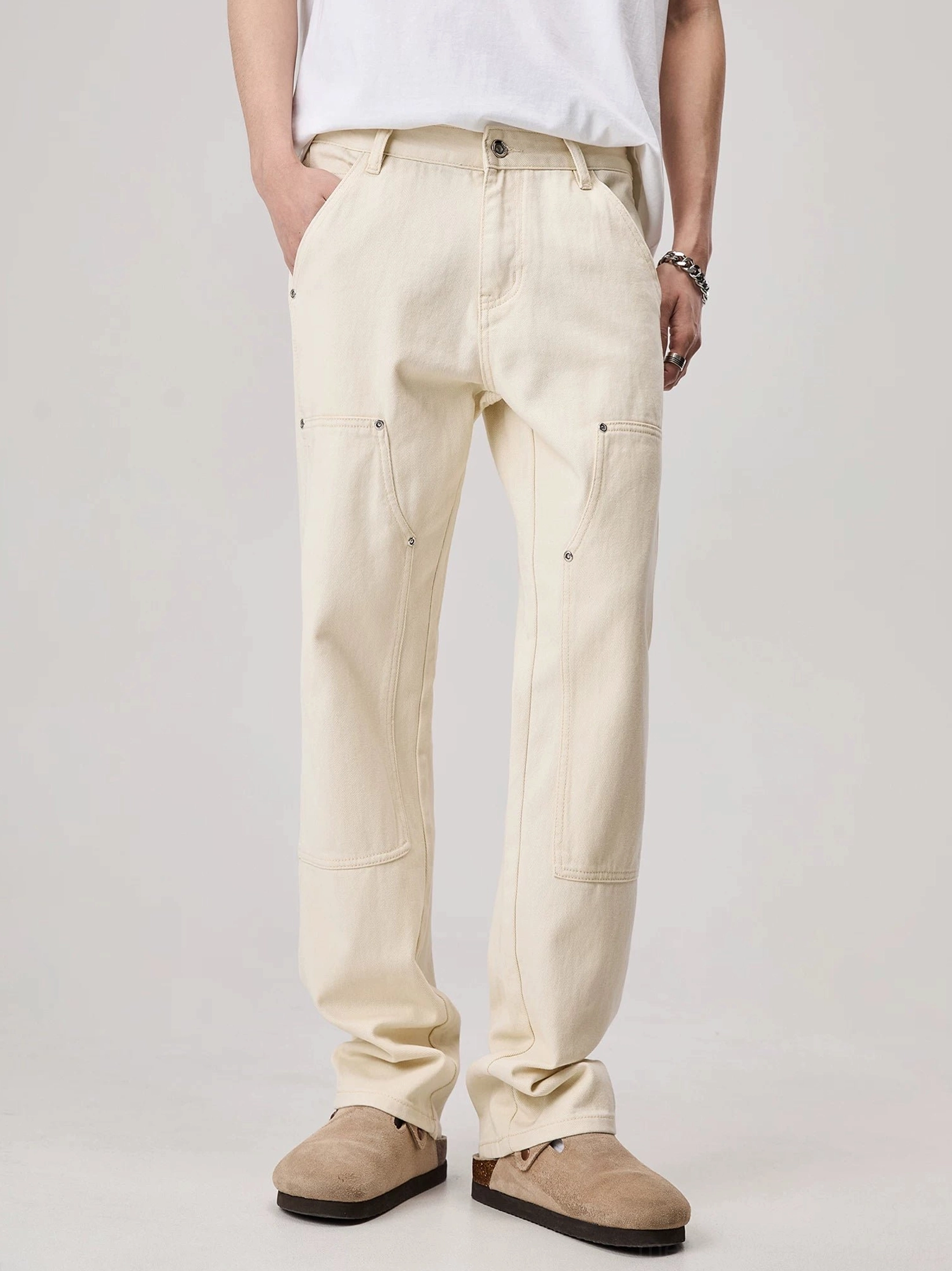 Men's apricot off-white rivet detail loose straight carpenter work pants front full body streetwear outfit