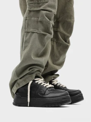Chunky rope lace platform sneakers styled with loose olive cargo pants in a low-angle Korean streetwear outfit