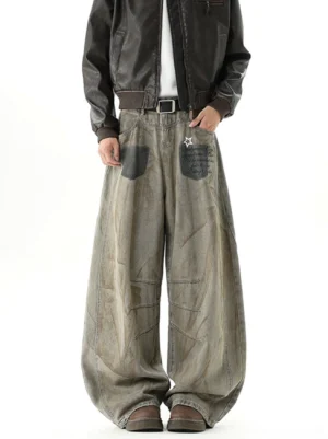 Front full-body view of rust brown vintage washed balloon jeans with ultra-wide legs, black patch pockets, star graphic, and articulated thigh seams styled with a brown leather jacket
