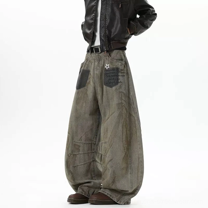 Left rear full view of dusty brown balloon jeans showing star and script detail on the back pocket, structured wide legs, and washed denim texture