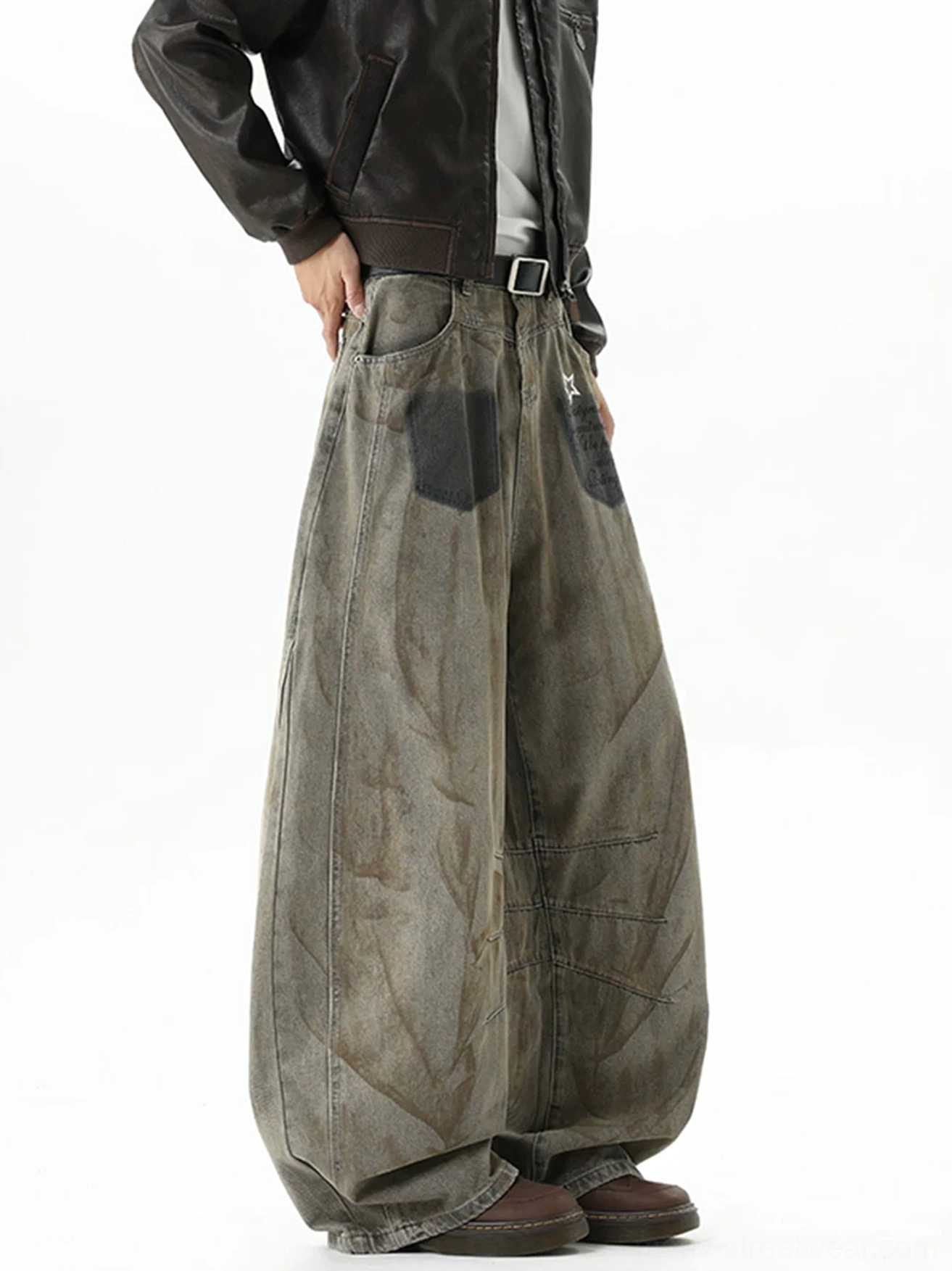 Left rear three-quarter view of vintage washed brown balloon jeans showing relaxed wide-leg drape, natural denim creases, and distressed workwear texture