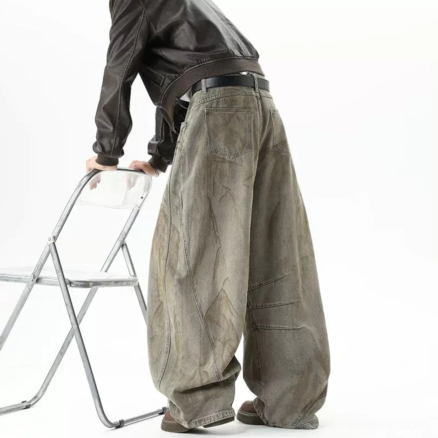 Rear three-quarter view of rust brown ultra-wide balloon jeans with full back detailing, loose leg drape, distressed wash, and contemporary streetwear styling