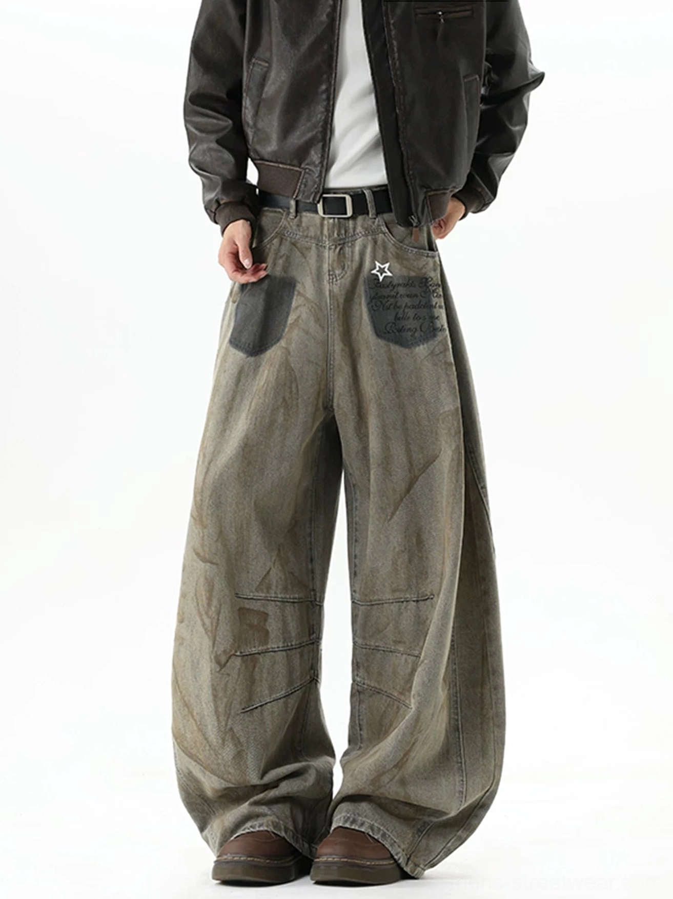 Right front three-quarter view of ultra-wide brown streetwear jeans with star patch pocket, faded wash, belt loops, and silver buckle styling