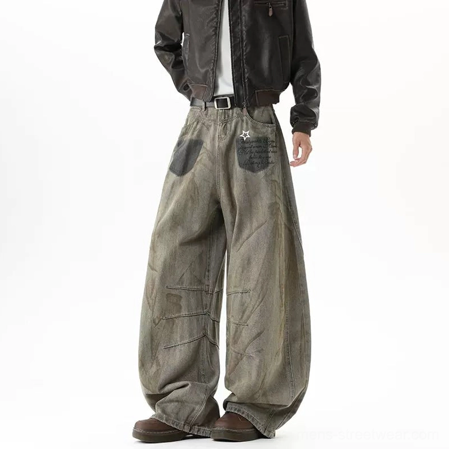 Right rear full view of wide-leg vintage streetwear jeans with rear star patch detail, flowing fabric drape, faded brown wash, and belt buckle