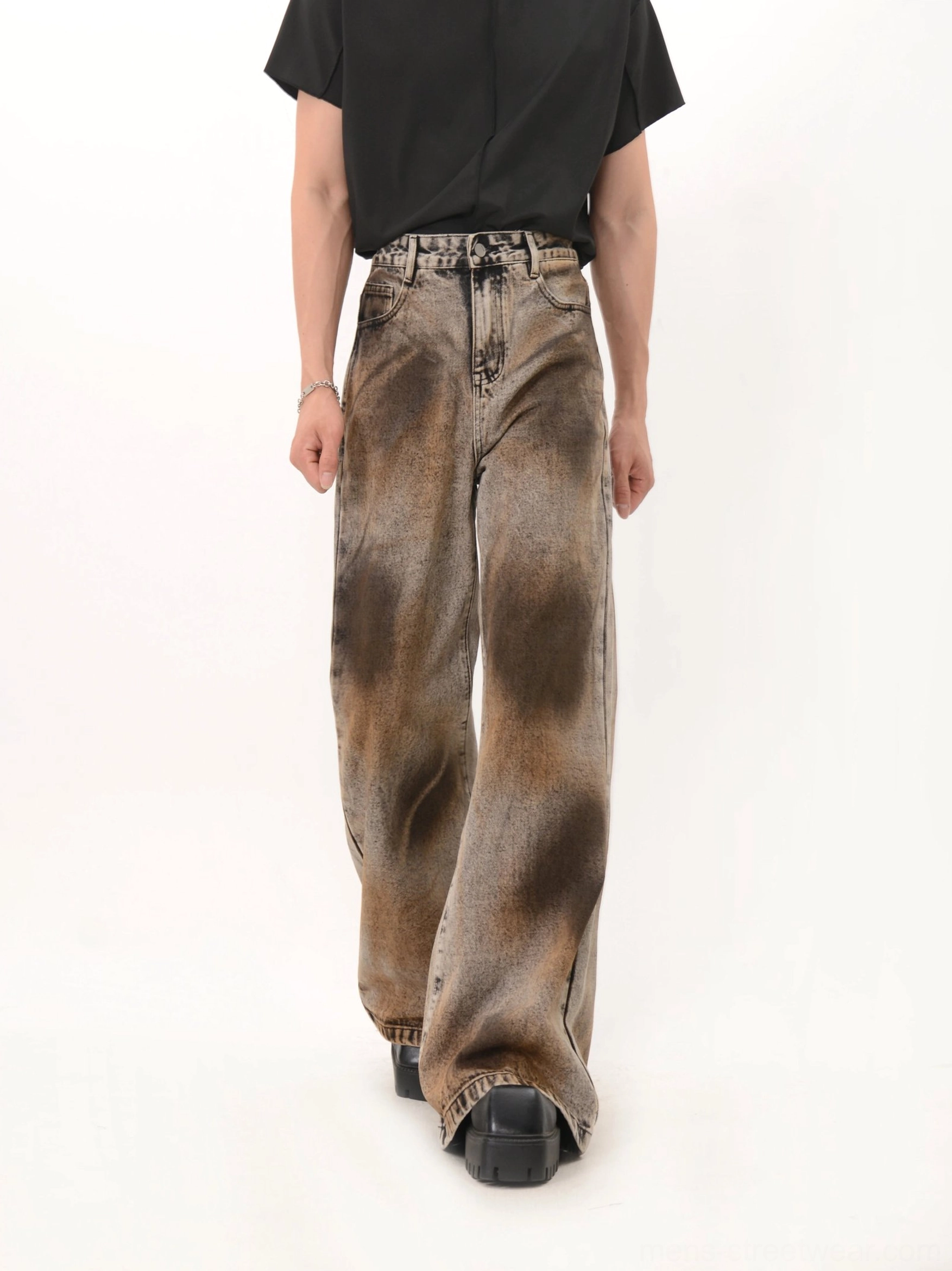 Rear full body view of black rust eclipse wash wide leg flare denim jeans with classic back pockets and long loose hem