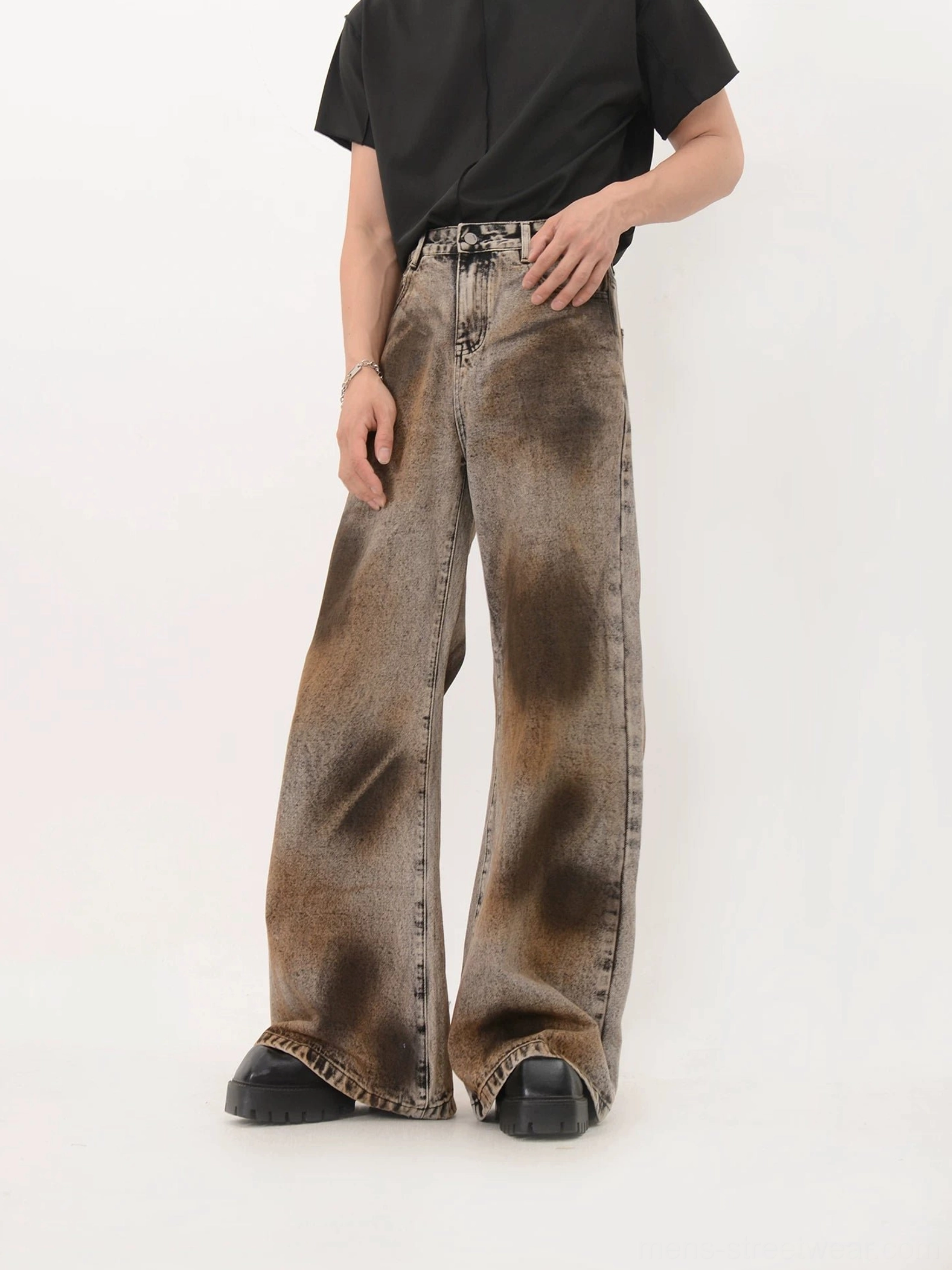 Vintage washed black wide leg denim jeans with brown gradient spray wash and exaggerated long flare silhouette