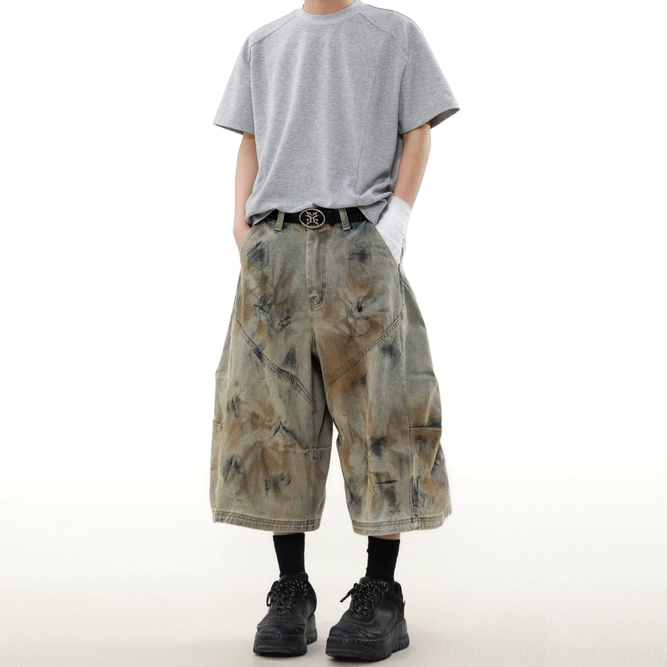 Front half-body styling view of loose cropped cargo denim shorts with distressed dye finish and Korean streetwear outfit