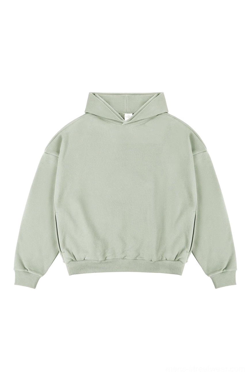 Sage green oversized Korean streetwear hoodie with relaxed drop shoulder silhouette