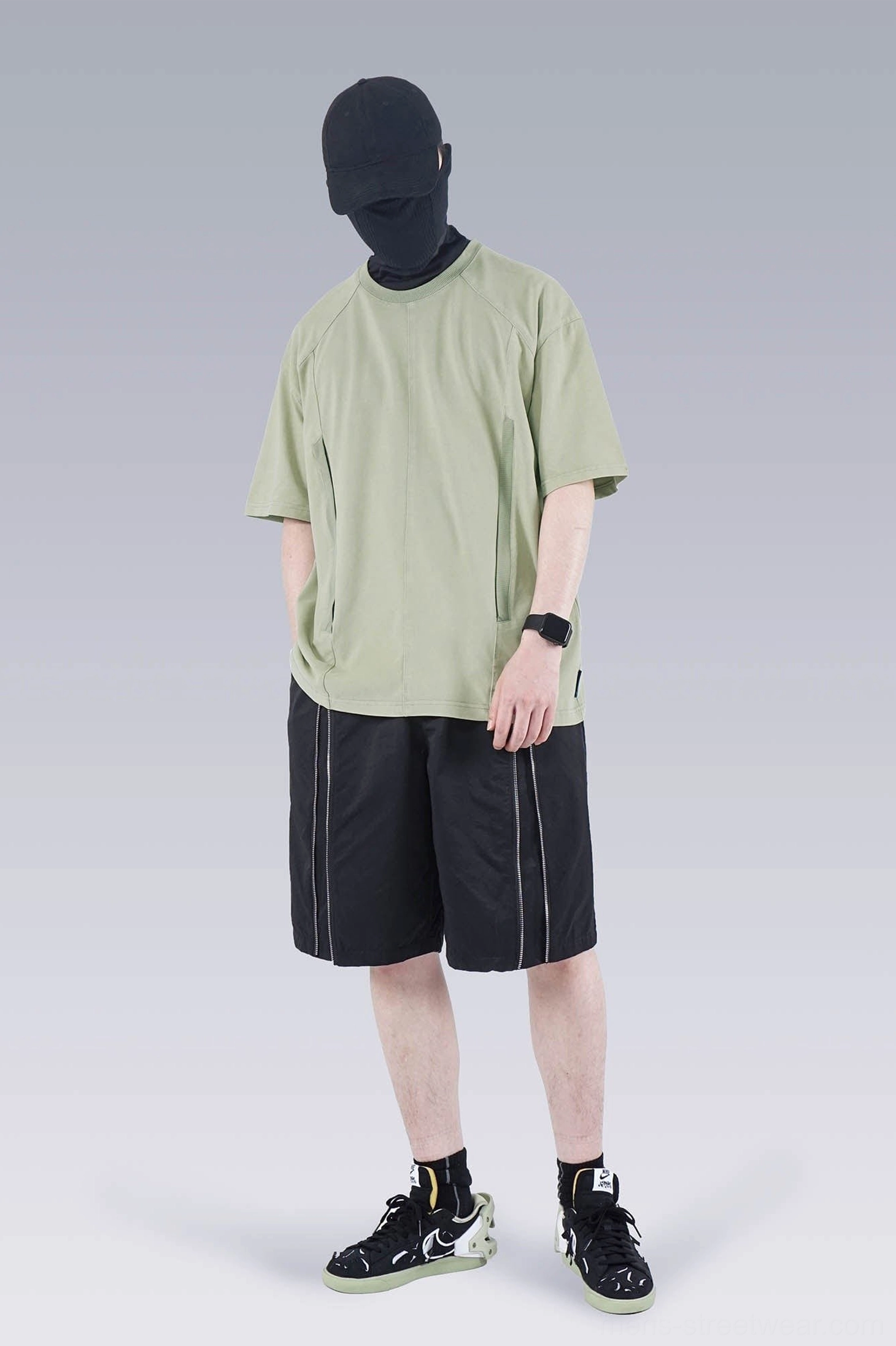 Sage green washed technical oversized T-shirt styled with black reflective track shorts and casual sneakers