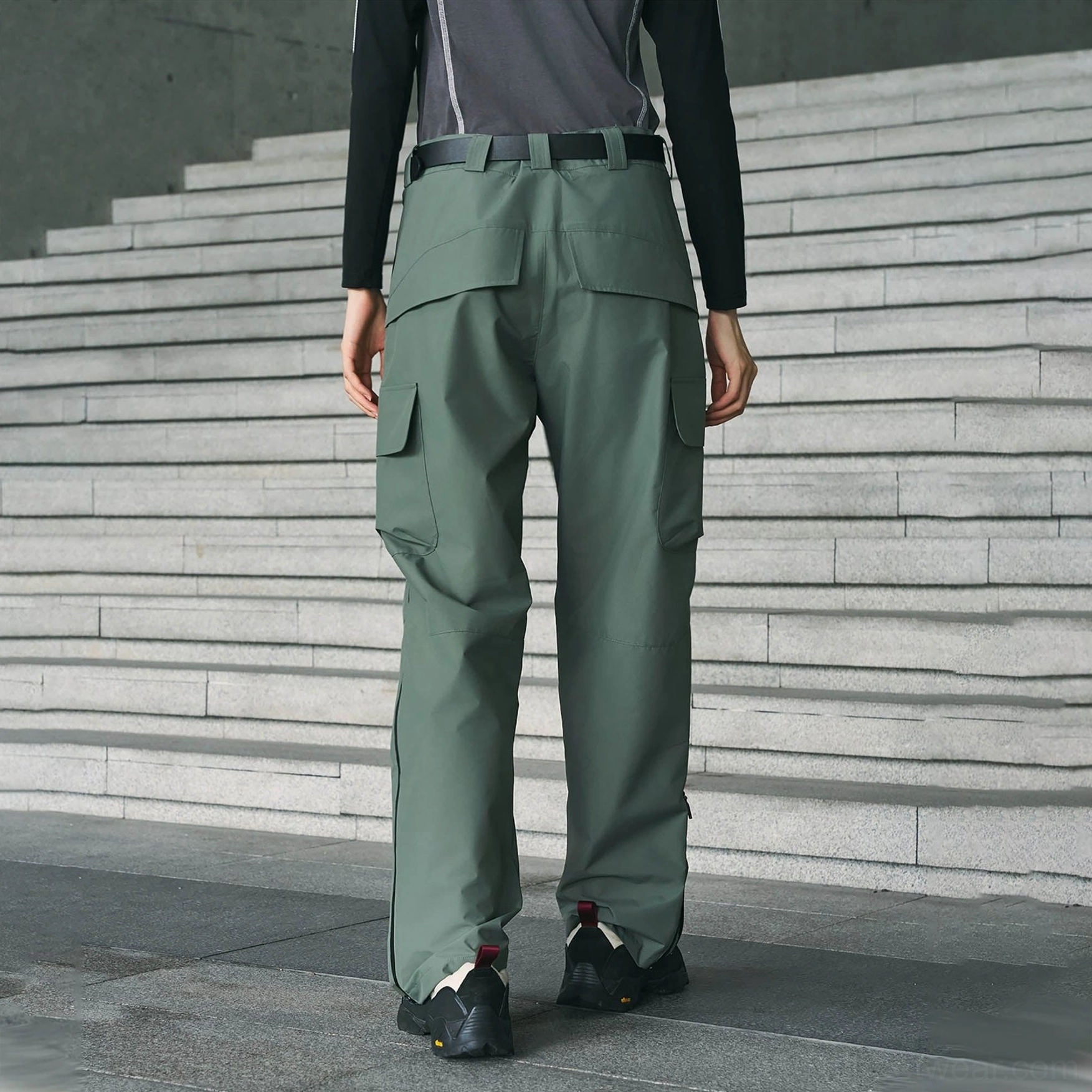 Sage green techwear cargo pants shown in a full front view with belt loops, cargo pockets, and a loose straight cut
