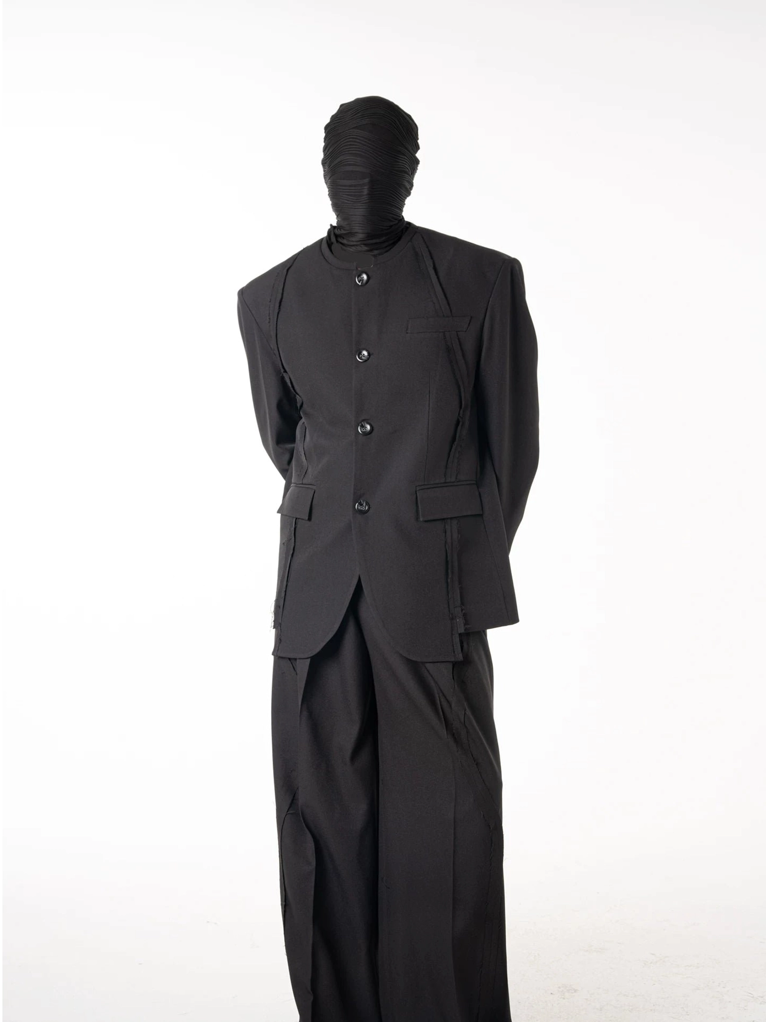 Full body front view of a sculpted black stand collar blazer and wide-leg tailored suit set in minimalist Korean streetwear style