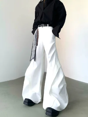 White sculpted eclipse wide-leg flare trousers with twisted vertical seams styled with a black shirt and platform loafers