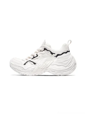 White sculpted leather chunky sneakers in right side profile with wavy distressed sole, black contrast lines, and rear pull tab