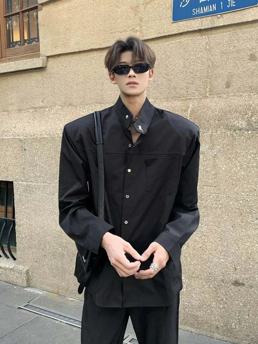 Black sculpted stand collar oversized button up shirt front full body view with structured minimalist silhouette