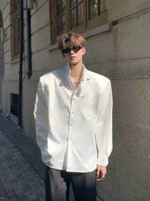 White sculpted stand collar oversized streetwear shirt front full body outfit on an urban stone street