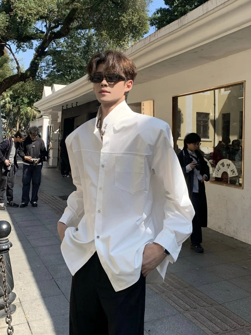 White oversized stand collar streetwear shirt with chest pocket styled as a clean Korean fashion outfit