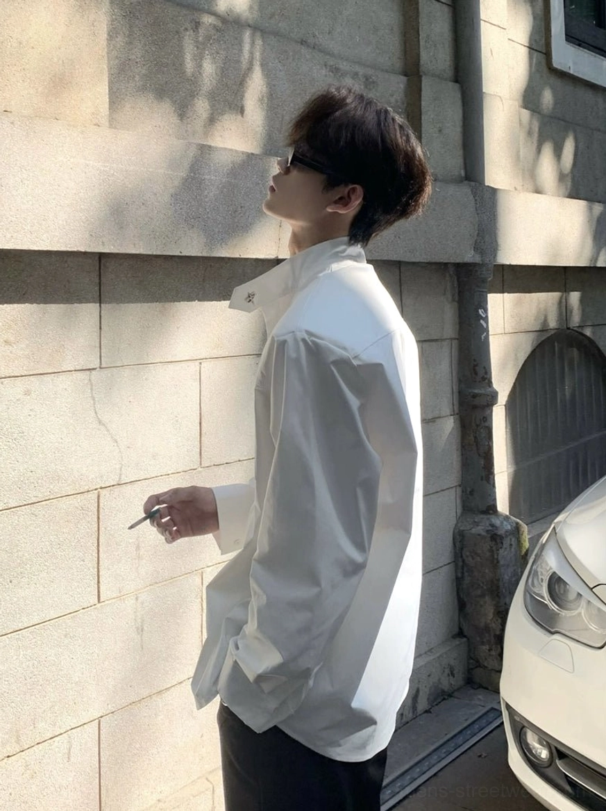 White long sleeve stand collar oversized shirt side profile showing loose drape and open collar styling