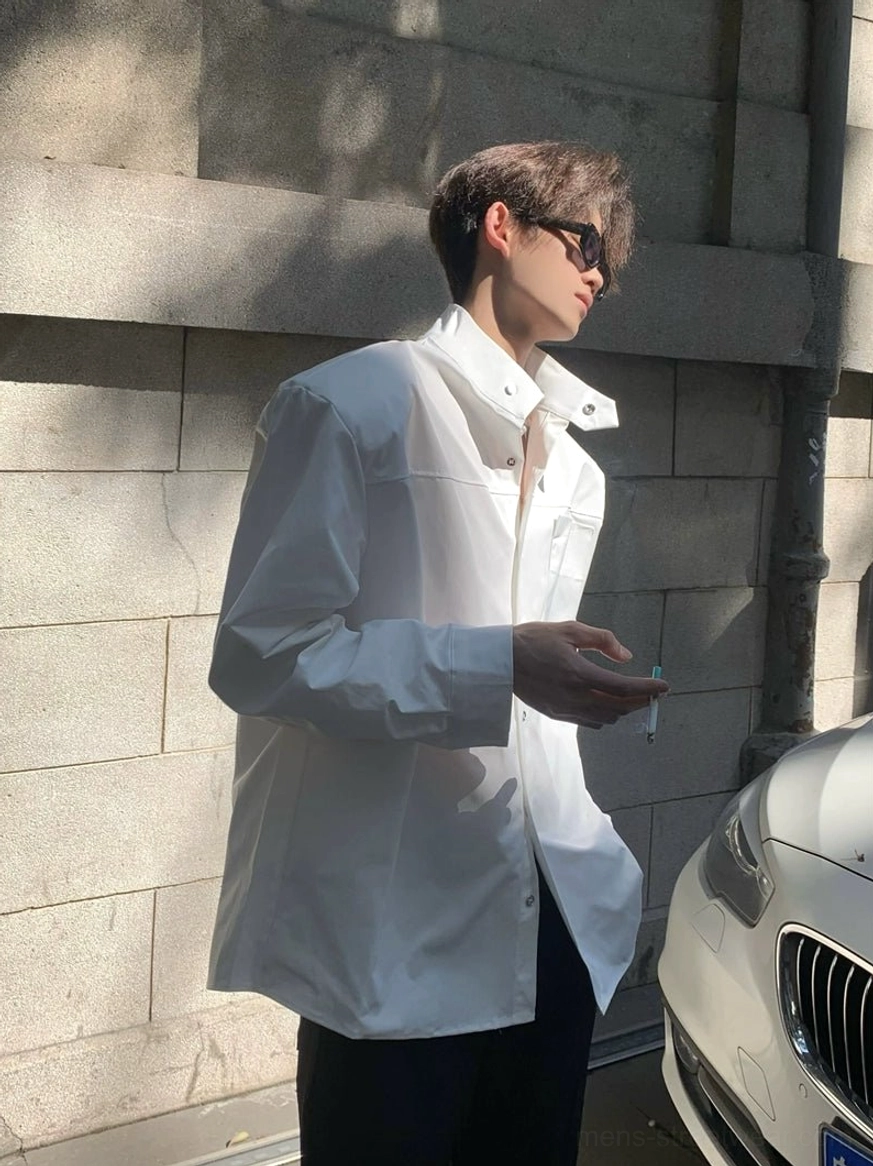 White oversized stand collar shirt side three quarter view showing dropped shoulders and relaxed streetwear silhouette