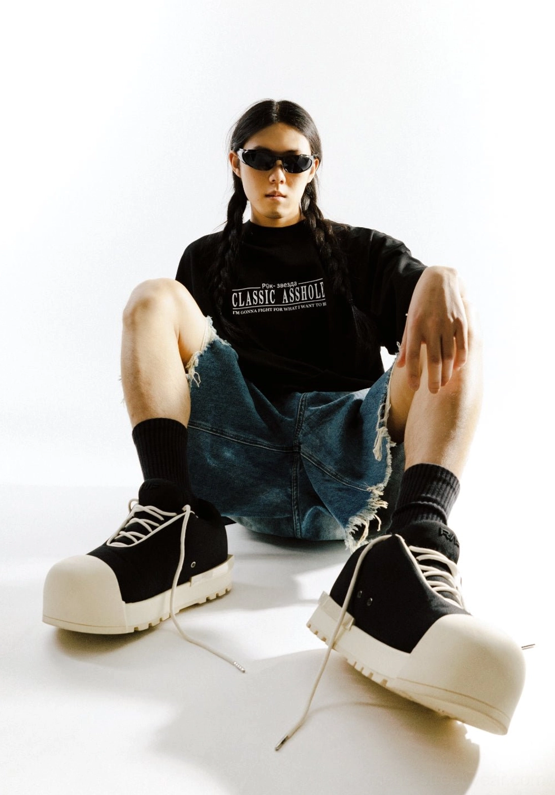 Front view of unisex black platform low boots worn with loose socks and relaxed Korean streetwear