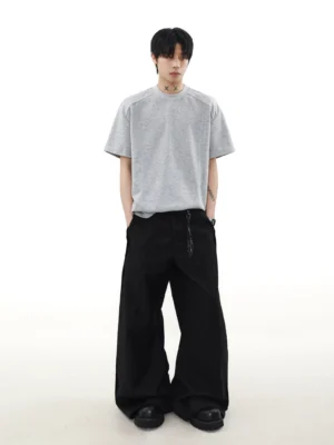 Full body view of heather gray Korean streetwear T-shirt with boxy relaxed silhouette and black wide leg trousers