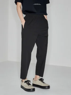 Black side-seam-free elastic waist cropped tapered pants shown in a full front streetwear outfit with platform loafers