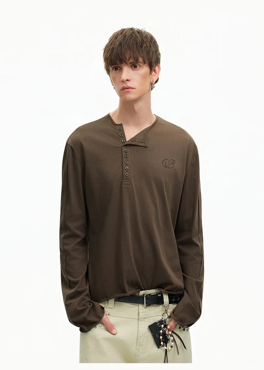 Casual Seoul-inspired outfit with a brown Henley long sleeve tee, light khaki trousers, belt, and decorative waist pendants