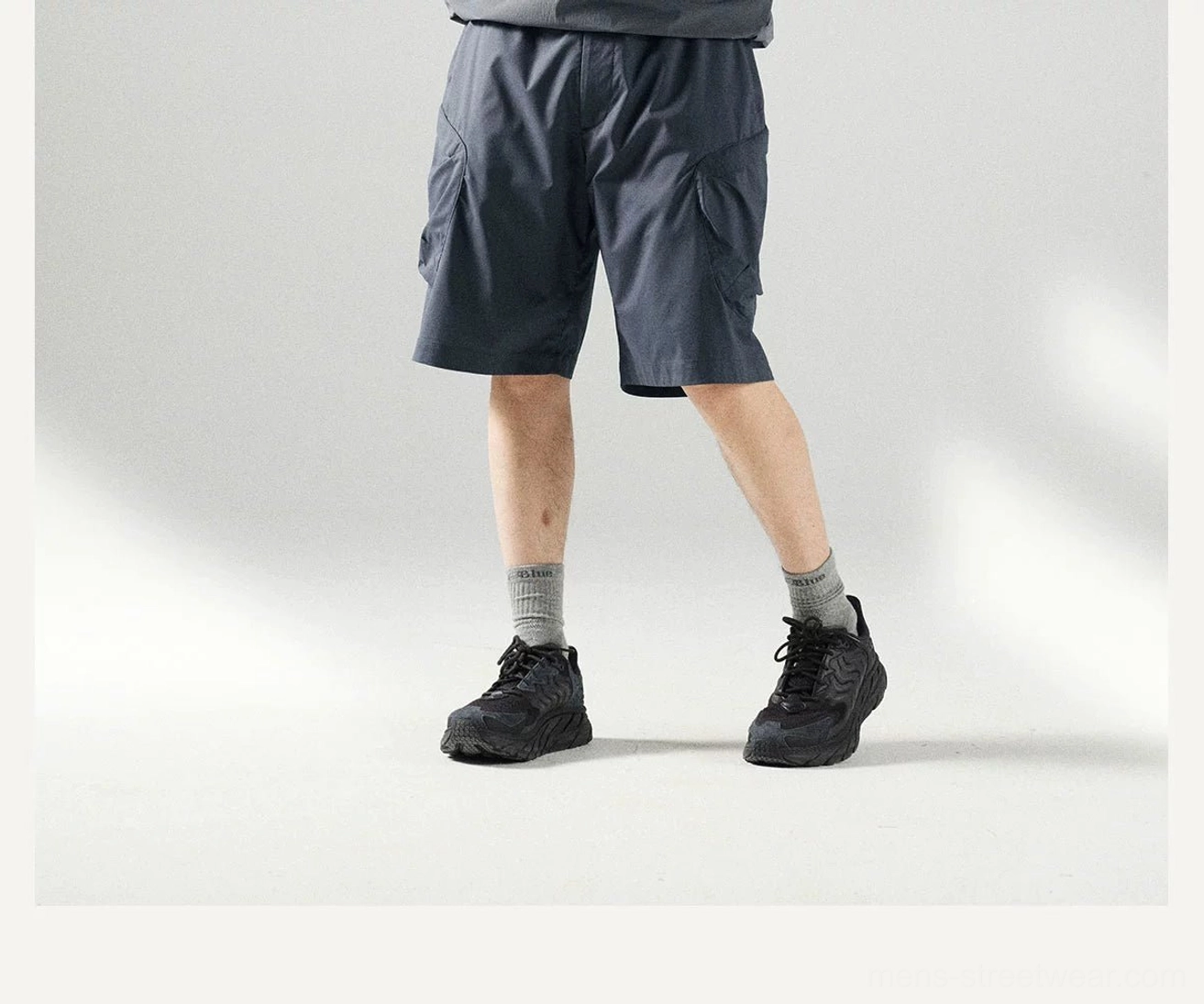 Seoul streetwear inspired men's cargo shorts with wide-leg proportions, breathable polyester construction, and functional pocket details