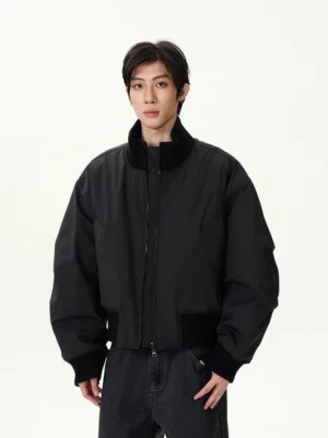 Shadow Fortress cropped black oversized bomber jacket front full body view with dark wash jeans