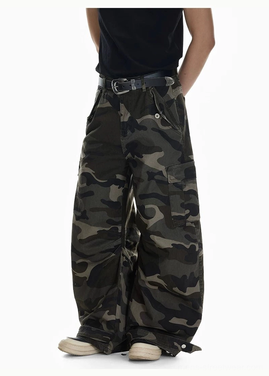 Shadow Ops camouflage adjustable wide leg cargo pants front side view with oversized fit and ankle strap details