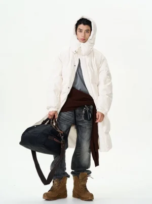 Front three-quarter view of charcoal black shadow wash straight leg jeans styled with layered winter streetwear outfit