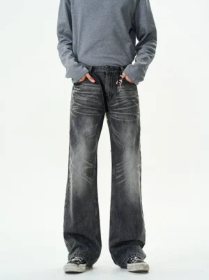 Front view of faded black straight leg jeans with relaxed fit worn with grey sweatshirt and canvas sneakers