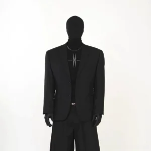Black minimal tailored streetwear blazer shown in a full front outfit with wide-leg trousers and high-neck graphic layer